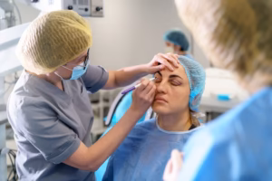 Medical professional marking a patient’s eyelids before blepharoplasty surgery.